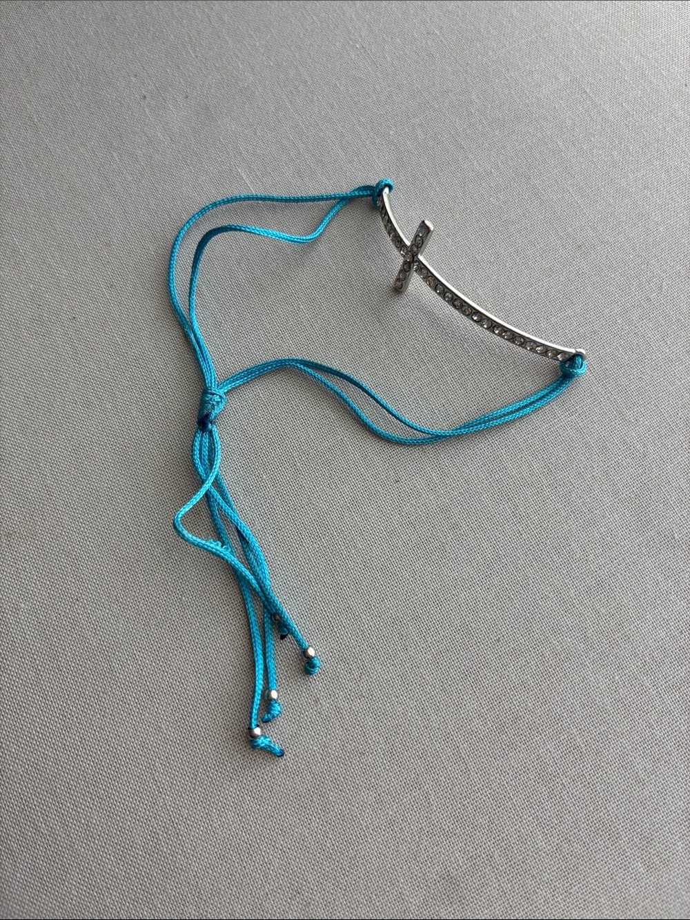Silver Cross Pendant Bracelet with Turquoise Cord